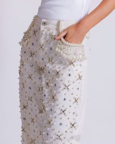 Please note that this style runs large and we recommend sizing two sizes down.  This wide leg jean features rhinestone-encrusted beadwork that is sewn entirely by hand. Intricate hand-beaded clusters of rhinestone, pearl, and glass beads sewn throughout. Wide leg with a high-waisted fit. Zip front and button fly closur Beaded Pants, Pearl Embellishment, Bead Clothes, Glass Dress, Pearls Outfit, Pearl Top, Beaded Jeans, Beaded Clothes, Glass Bead