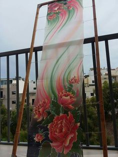 a large painting on the side of a building next to a wooden pole and ladder