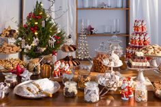 a table filled with lots of desserts and cookies on top of wooden counter tops