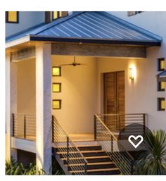 a house with stairs leading up to the front door