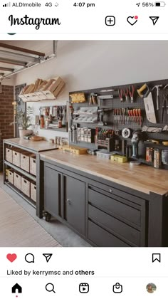 a workbench with lots of tools hanging on the wall and shelves above it