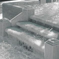 the water is running down the steps in the fountain