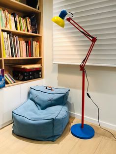 a blue bean bag chair sitting in front of a book shelf