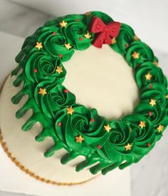 a cake decorated with green icing and gold stars