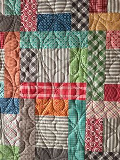 a close up of a quilt with many different colors