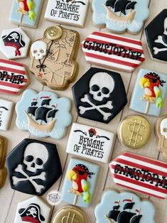 decorated cookies are arranged on a table with pirate signs and other items in the background