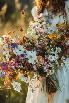 a woman holding a bouquet of flowers in her hands