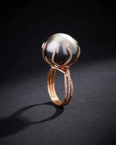 This ring perfectly encapsulates the ethereal beauty of a Tahitian pearl, renowned for its luminous sheen and captivating allure. This one-of-a-kind ring is not just a jewelry piece but a work of art. Cradling the pearl are delicate crescents of rose gold, reminiscent of the tender arms of a crescent moon, each meticul Luxury Formal Rings With Pearl Drop, Unconventional Engagement Rings Pearl, Pearl High Jewelry Ring, Luxury Round Rings For Jewelry Making, Beautiful Jewelry Pearl, Black Pearl Diamond Ring, Artistic Jewelry Pearl, Unusual Rings Pearl, Unique Engagement Rings Non Traditional Pearl