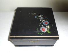 an old black box with flowers painted on it