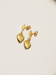 The earrings are made with 14k yellow gold, one gram in weight featuring hollow dangling hearts, the total size 18mm long x 9mm wide, in excellent condition.