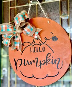 a wooden sign that says hello pumpkin hanging on a door