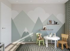 a child's room with mountains painted on the wall and two chairs in front