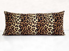 a leopard print pillow on a white surface