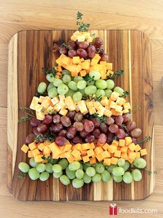 a christmas tree made out of cheese and grapes