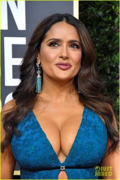 an image of a woman wearing a blue dress and big cleavages at the golden globe awards