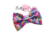 a colorful bow tie is shown on a white background with the words pretty in pink