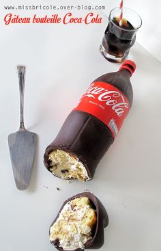 there is an ice cream in the wrapper next to a coke bottle and spoon