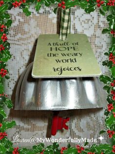 a metal bell with a christmas message on it