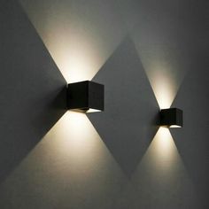 two square lights are on the wall next to each other