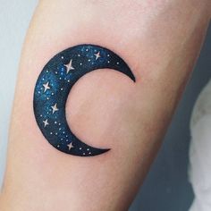 a small crescent tattoo with stars on the side of its arm and it's moon in the middle