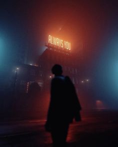 a man walking down a street in front of a neon sign that says always you