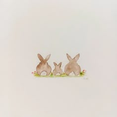 two brown rabbits sitting on top of each other