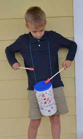 a young boy holding a plastic cup and toothbrush