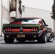 a red and green car is parked on the street