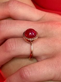 Breathtaking in its classic simplicity and timeless design, this vibrant eye catching ruby cabochon with a subtle sheen is accentuated with a pave of sparkling fancy cognac red diamonds. Alone or stacked with the rings from our collection,it is absolutely perfect. Ruby cabochon 11mm Diamonds size 1.1mm 9K solid rose gold Follow us on Instagram: https://www.instagram.com/missionewyork/ Ruby Ring Cabochon, Formal Rose Gold Ruby Ring With Round Cut, Ruby Cabochon Ring, Gold Cocktail Rings, Red Diamonds, Cognac Diamonds, Ruby Rings, Gold Cocktail Ring, Crystals Jewelry