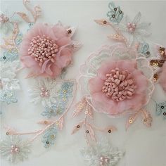 three pink flowers with pearls and sequins