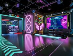 an empty room with neon lights and posters on the walls