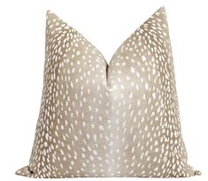 a white and beige pillow with an animal print pattern on it's front side