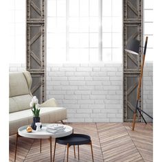 a living room with white brick walls and wooden flooring