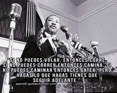 martin luther king speaking at a podium with microphones in front of him and an image of