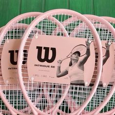 pink tennis rackets are stacked on top of each other