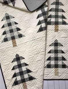 two black and white quilts with trees on them