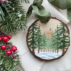 a christmas ornament with pine trees on it