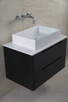 a white sink sitting under a faucet in a bathroom