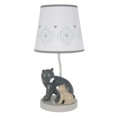 a lamp with a bear and cub figurine next to it on a table