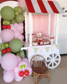 there is a small cart with balloons on it and some other things in the background