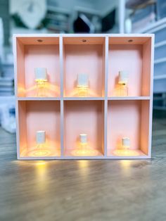 an open shelf with candles in it on the floor