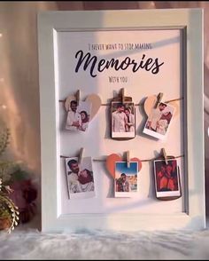 a white frame with pictures hanging from clothes pins on it and the words, i never want to be making memories with you