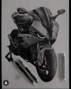 a drawing of a motorcycle is shown on the wall next to some pens and markers