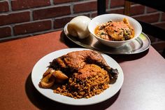 two plates of food on a table next to a bowl of soup and an onion