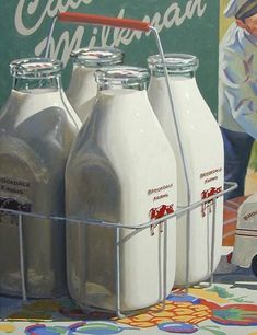 three bottles of milk are sitting on a table