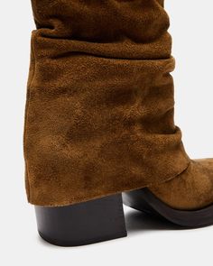 COMPELLING + RUGGED + CONTEMPORARY The PIA boot features a chunky square toe and block heel peeking out from a foldover design with a curved topline. 3.25 inch heel height 12 inch shaft circumference 6.25 inch shaft height Suede upper material Textile lining Synthetic sock Synthetic sole Imported Women's Booties, Steve Madden Store, Apparel Merchandising, Boot Cuffs, Fall Shoes, Chestnut, Block Heels, Bootie Boots, Womens Boots