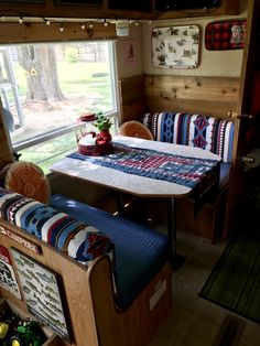 a table and couch in a small room with a window looking out onto the yard