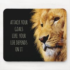 a mouse pad with a lion's face and the words, attack your goals like your life demands on it