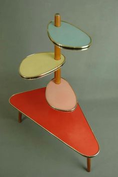 three tiered trays on top of each other in different colors and shapes,