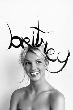 a black and white photo of a woman with the word beauty written on her head